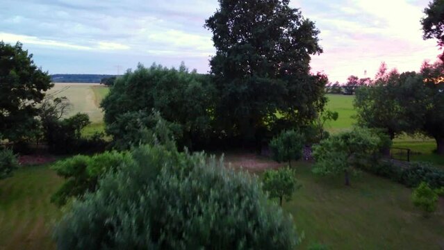 empty pool evening pink sunset.
Smooth aerial view flight overfly drone footage 
at Countryside village Hainichen in Europe Saxony Anhalt, summer 2022. 4k Cinematic view from above by Philipp Marnitz