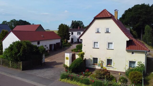 Restored agricultural farm. Spectacular aerial view flight lift off aerial drone footage
at Countryside village Hainichen Europe Saxony Anhalt, summer 2022. 4k Cinematic from above by Philipp Marnitz