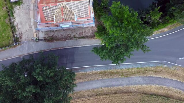 House on lake, roof work
Buttery soft aerial view flight bird's eye view drone footage
at Countryside village Hainichen in Europe Saxony Anhalt, summer 2022. 4k Cinematic from above by Philipp Marnitz