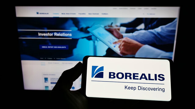 Stuttgart, Germany - 01-29-2022: Person holding mobile phone with logo of Austrian chemical company Borealis AG on screen in front of business web page. Focus on phone display.
