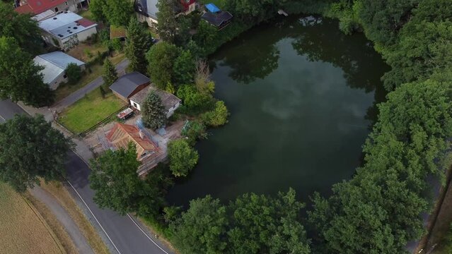 No people small lake clouds reflected in water
Wonderful aerial view flight stable tripod drone footage
in Hainichen Europe Saxony Anhalt at summer 2022 4k Cinematic view from above by Philipp Marnitz