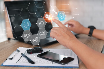 Car insurance and maintenance of car Building trust, and customer satisfaction, Technology on virtual screen concept, laptop smartphone checklist and toy car on wood table in office