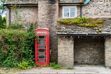 Obraz premium old red telephone box in countryside