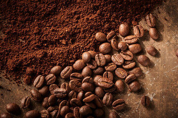 Roasted coffee beans different sort ground and whole isolated close up on brown grunge background