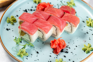 uramaki sushi on a pale blue plate close up