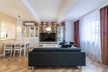 Living room with sofa bed, TV viewing area and dining table