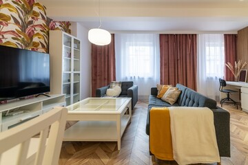 Living room with sofa bed, TV viewing area and dining table