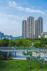 a vertical photo of landscape and high-end residential buildings inside the honey park at downtown shenzhen, china