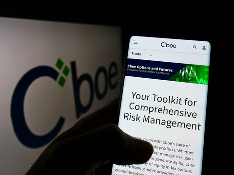 Stuttgart, Germany - 01-30-2022: Person holding cellphone with webpage of US financial company Cboe Global Markets Inc. on screen with logo. Focus on center of phone display.