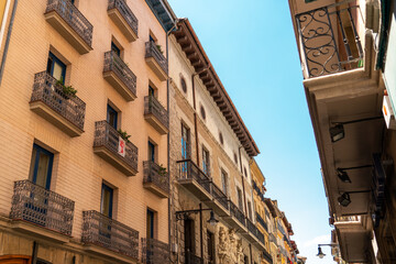 Fototapeta premium Beautiful building architecture in Pamplona city. Coloured buildings, beautiful façade typically for the Navara province, in north of Spain. City in preparation for the San Fermin party.