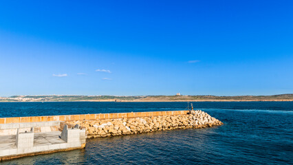 Obraz premium Cirkewwa Passenger Terminal, Malta. Sunny, mid day, few clouds. Photo taken in January 2022. Plenty of negative space on the top.