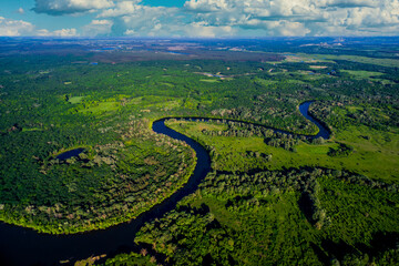 river flows through the valley in summer. Beautiful landscape cloudy sky. Aerial view. The bend of the river. Panorama. River landscape. Drone photography