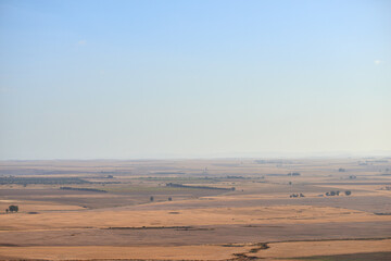 Aerial view of dry brown farm land after harvest in Western Cape, South Africa. The sustainable ecological farming landscape during a drought season with a lack of rain for the grass and plants