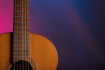 Fototapeta na wymiar Classical guitar on a gelled color background 