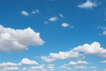 Naklejka na ściany i meble Panoramic blue sky with fluffy clouds. Vibrant photo for backdrops and backgrounds