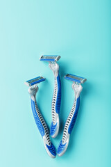 Blue shaving machines in a row on a blue background with ice cubes