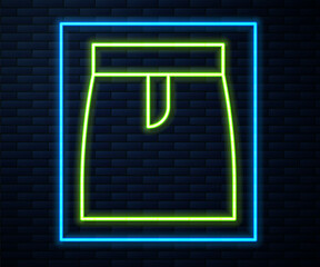 Glowing neon line Skirt icon isolated on brick wall background. Vector