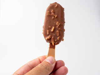 Chocolate Ice Cream with almonds on a stick. Ice cream on a white background.