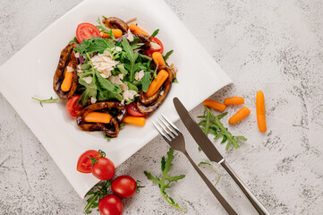 Dish of green salad with arugula, vegetables and cheese parmesan