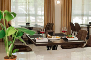 Served table with dishes and red wine in the restaurant