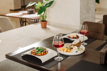 Served table with dishes and red wine in the restaurant