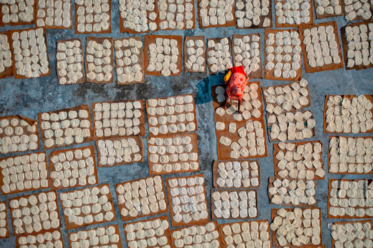 Aerial view of Women at work on the preparation of natural fabric, Barga, Rajshahi, Bangladesh.