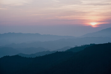 wide view  layer of mountain with sunrise background