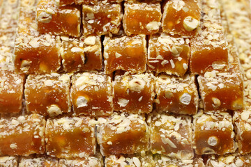 Traditional Turkish dessert lokum in a market. Sweet delight made of fruit juice and nuts