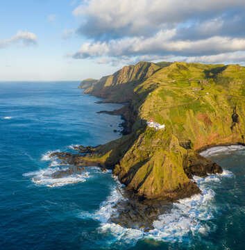 Aerial View of lighthouse on the peak of the cliff overlooking the ocean, Santo Espirito, Azores, Portugal.