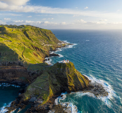 Aerial View of lighthouse on the peak of the cliff overlooking the ocean, Santo Espirito, Azores, Portugal.