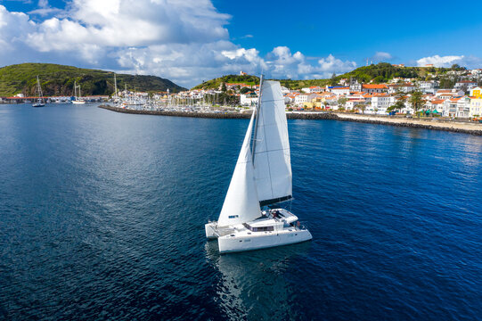 Aerial View of Sailboat while sailing in a regatta off the coast on Pico Island, Azores, Portugal.