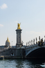 Fototapeta na wymiar View of the Alexander III Bridge and the golden statues