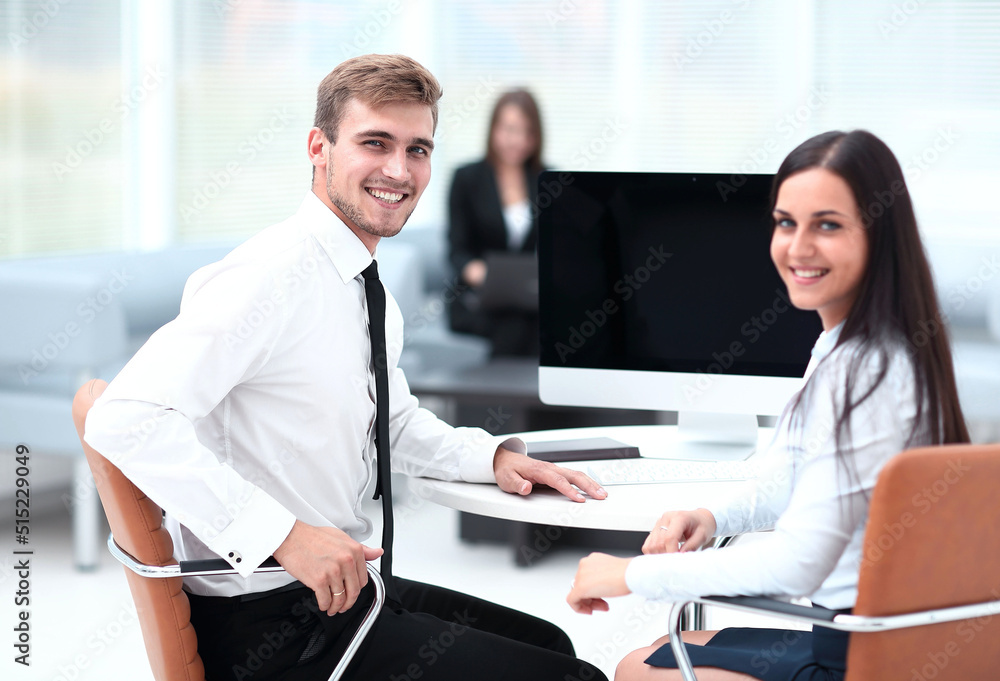 Canvas Prints members of the business team sitting at Desk and looking at camera .