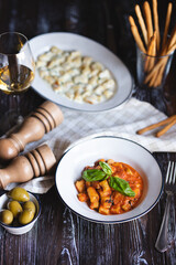 Appetizing dish on a dark wooden table. Dinner for two.