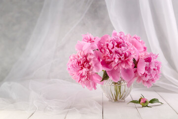 Bouquet of pink peonies in a vase on a wooden table. Gift Valentine's Day