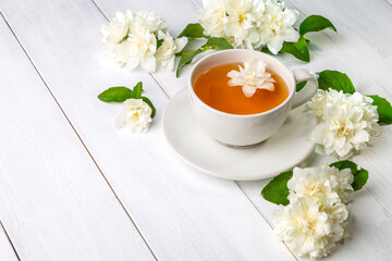 Jasmine tea in a cup on a wooden background. Copy space