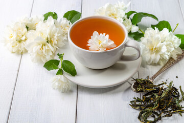 Jasmine tea in a cup on a wooden background. Copy space.