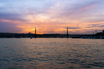 Sunset over the city of Istanbul, with a mosque in the photo, with the blue and orange sky, sailing on the Bosphorus