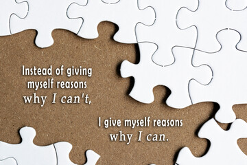 Motivational quote on white jigsaw with some missing pieces on brown background.