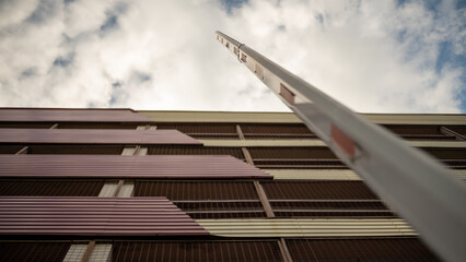 Fototapeta premium Open barrier in front of a multi-level parking, view from the bottom up