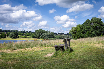 Wooden bench on the shore of Bewl Water, Kent, England