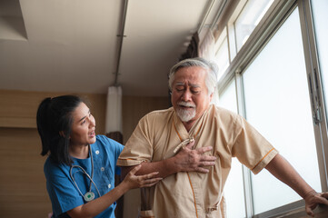 Fototapeta premium Senior male patient admitted in hospital holding chest due to pain suffering from heart attack