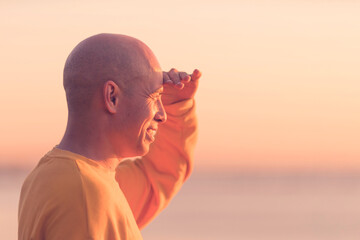 Young athletic man looking into the distance and smiling outdoors