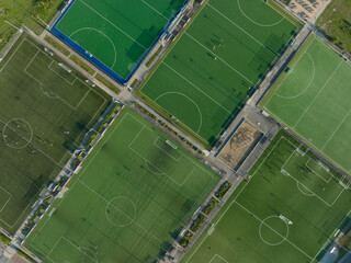 Recreational green grass active sports hockey and football fields overhead top down view....