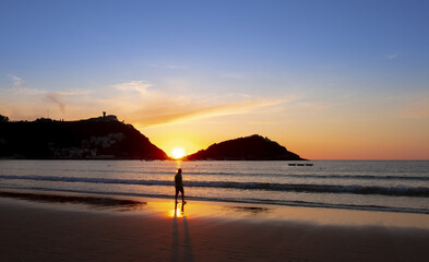 La Concha beach and bay at sunset in the city of Donostia-San Sebastian, Euskadi