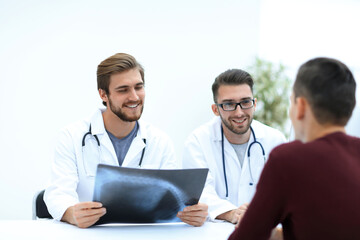 Fototapeta premium group of doctors welcoming their customer with a handshake