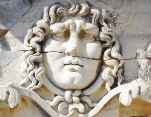 Closeup of a face carved on marble in classical style by ancient Greeks at the Temple of Apollo in Didyma. An impressive ruined sanctuary or statue in Hellenic city of Miletus, in southwest Turkey