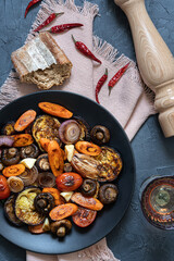 Grilled  vegetables :eggplant,mushrooms,tomatoes,carrot,onion.  Healthy vegetarian meal. Food photography on dark background. Top view.