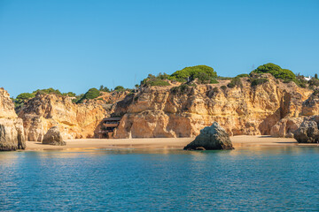Fototapeta na wymiar Algarve coast with the cliffs, caves and beaches seen from the sea