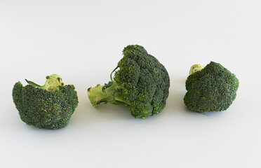 Broccoli on a white background. three green broccoli